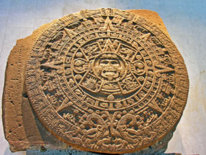 photo of stone relief carving, circular fragment, in the shape of an intricately carved sun