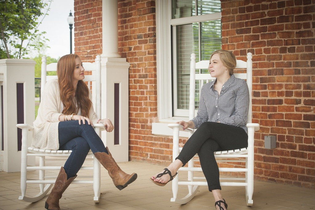 Students talking on a porch