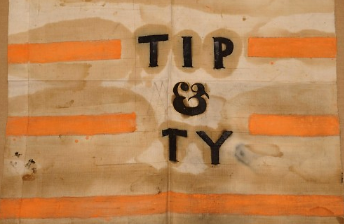 “Tippecanoe and Tyler Too” was a popular and influential campaign song and slogan, helping the Whigs and William Henry Harrison (with John Tyler) win the presidential election in 1840. Pictured here is a campaign banner with shortened “Tip and Ty,” one of the many ways that Whigs made the “log cabin campaign” successful. Wikimedia, http://commons.wikimedia.org/wiki/File:Tip_and_Ty_banner.jpg. 