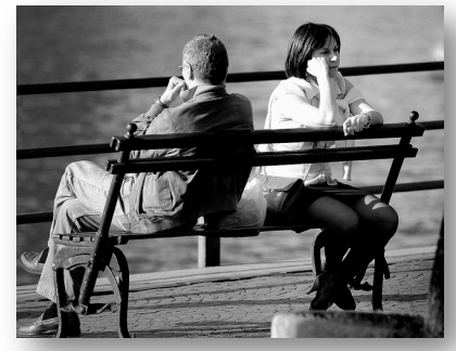 two people sitting on a bench and observing the surroundings