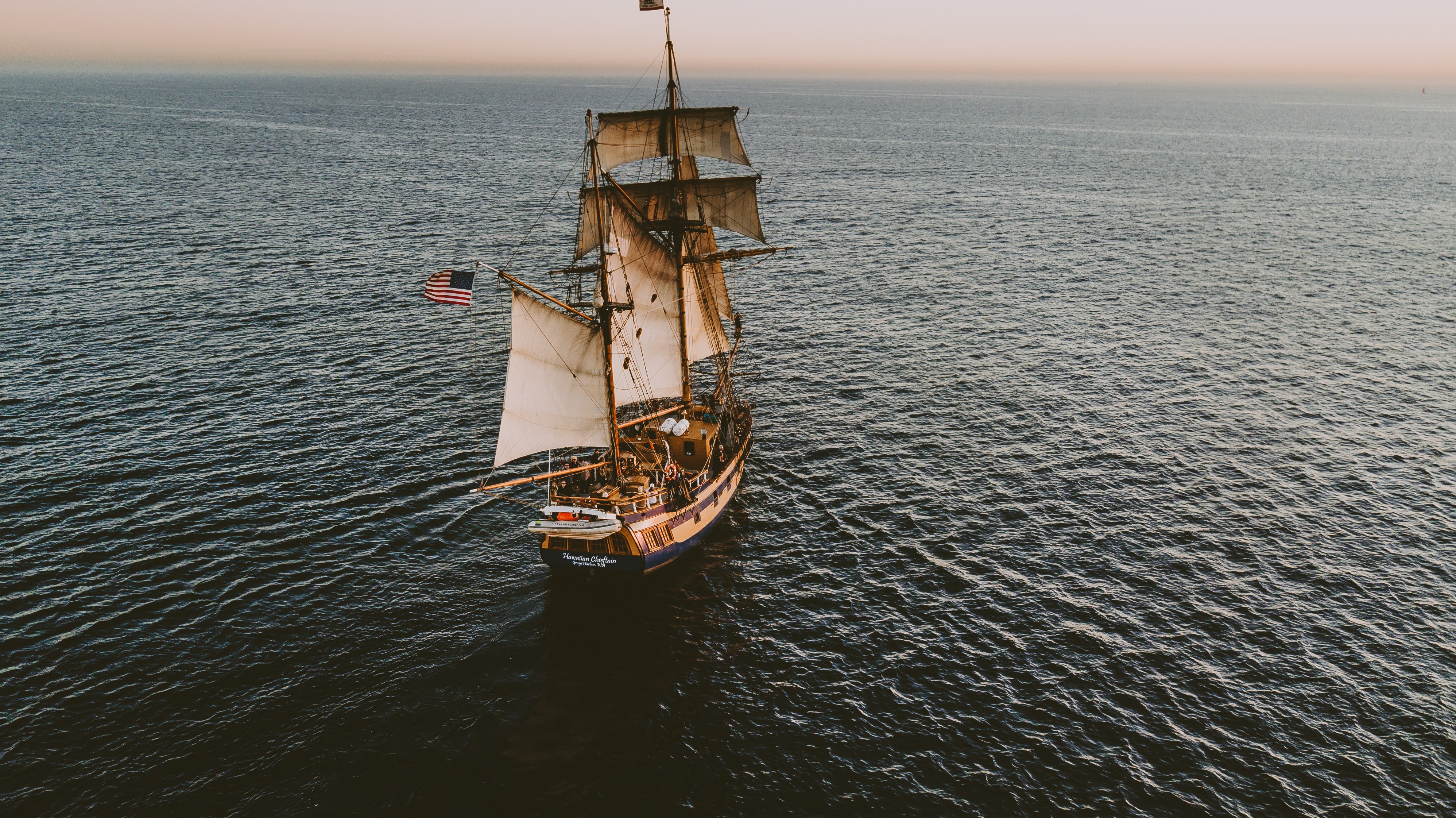 an old ship sailing on the ocean