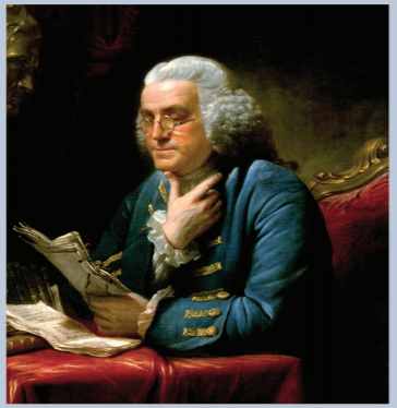 Benjamin Franklin at a desk reading a letter. Franklin is wearing glasses (bi-focals?)
