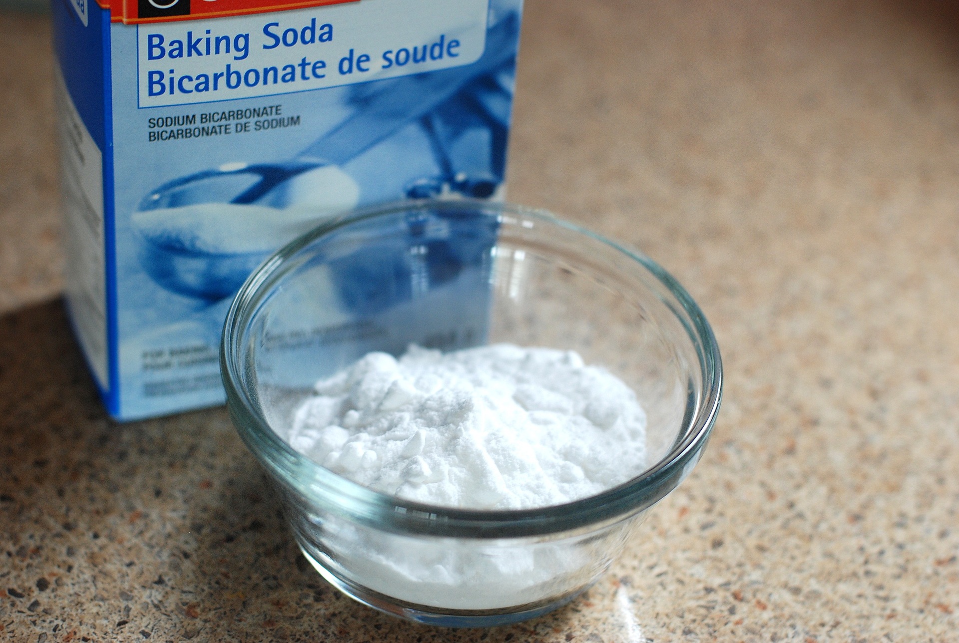 a box of baking soda with some in a bowl