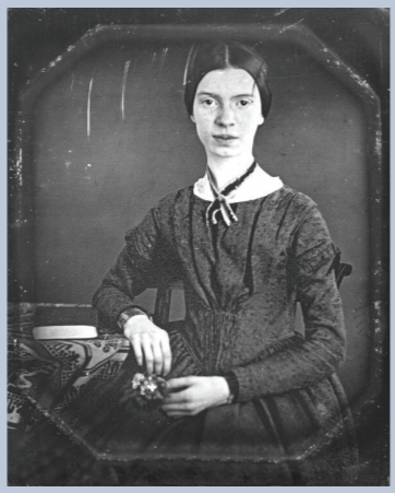 Daguerreotype of the poet Emily Dickinson, taken circa 1848. She is sitting facing forward, hair tight to her face, parted in the middle, black dress, hands folded in a relaxed pose on her lap
