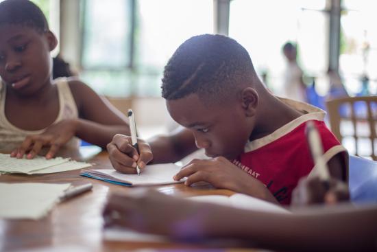 a boy focusing very carefully on his school work