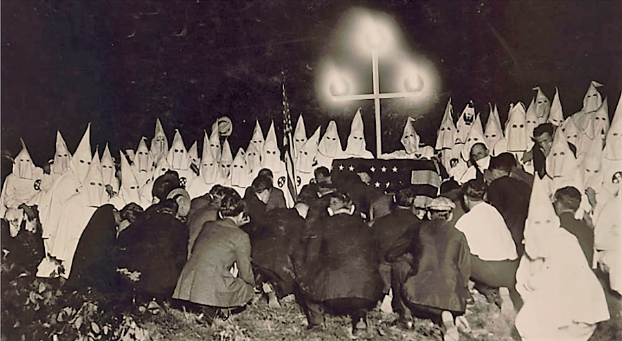 This photo by popular news photographers Underwood and Underwood shows a gathering of a reported 300 Ku Klux Klansmen just outside Washington DC to initiate a new group of men into their order. The proximity of the photographer to his subjects for one of the Klan’s notorious night-time rituals suggests that this was yet another of the Klan’s numerous publicity stunts. Underwood and Underwood, “Klan assembles Short Distance from U.S. Capitol,” (ca. 1920’s). Library of Congress.