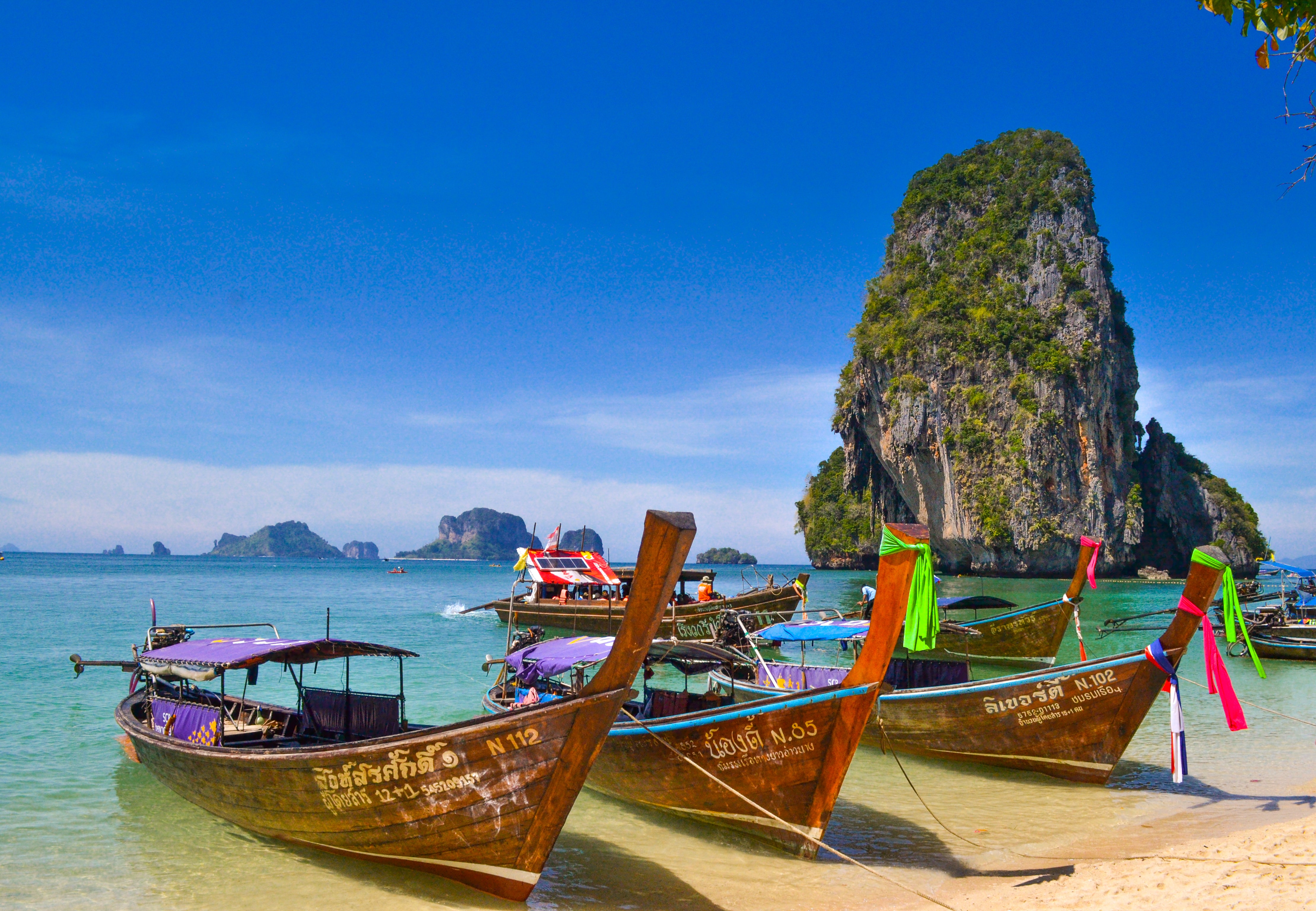 Three boats on a Thai beach. 