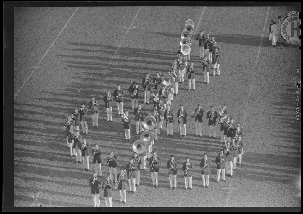 Photo of Harvard band forming music notes on field, Harvard vs. Brown, 1949