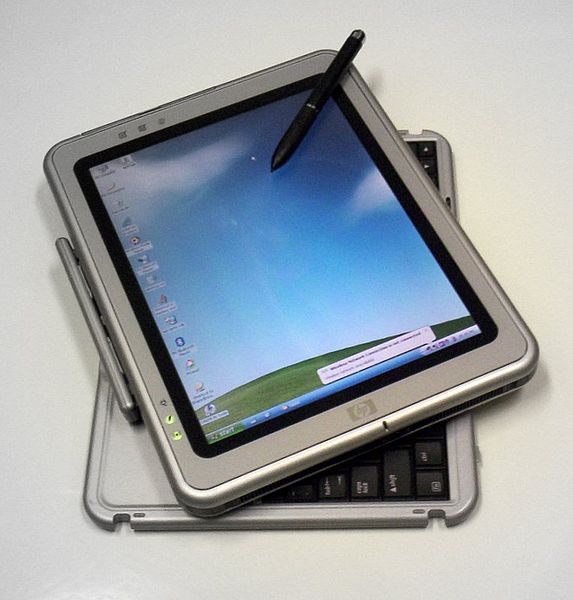 Photo of HP Tablet PC running Windows XP Tablet PC Edition. The tablet is partially rotated to reveal the corners of its keyboard.