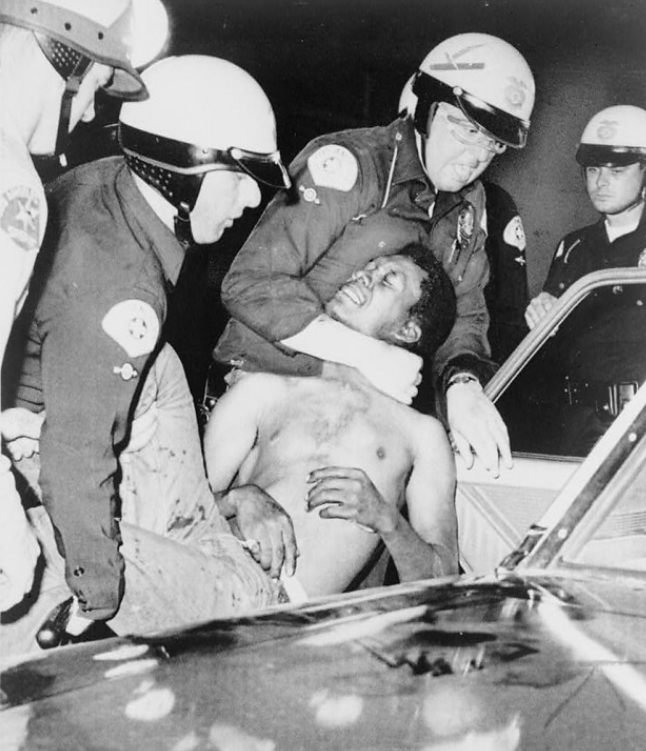 Los Angeles police hustle rioter into car, August 13, 1965, Wikimedia, http://commons.wikimedia.org/wiki/File:Wattsriots-policearrest-loc.jpg. 