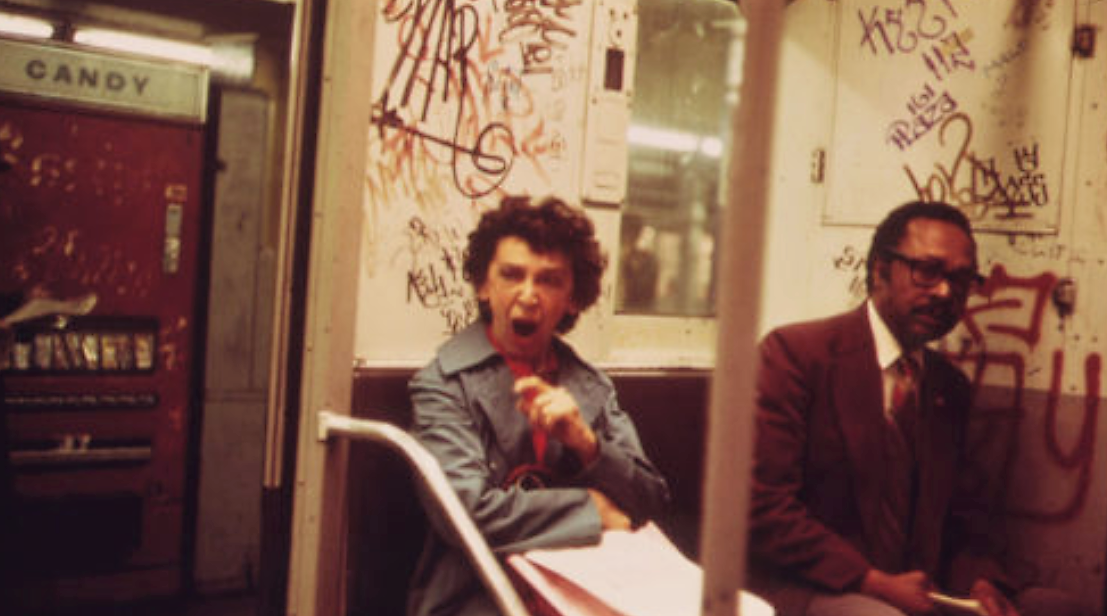 "Urban Decay" confronted Americans of the 1960s and 1970s. As the economy sagged and deindustrialization hit much of the country, many Americans associated major cities with poverty and crime. In this 1973 photo, two subway riders sit amid a graffitied subway car in New York City. Erik Calonius, "Many Subway Cars in New York City Have Been Spray-Painted by Vandals" 1973. Via National Archives (8464439).