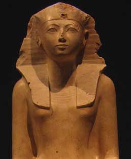 The first picture is of a stone statue of the female queen, Hatshepsut. Here, the queen wears the royal crowing while looking ahead stoically. Her uncovered upper body reveal breasts denoting her female form.