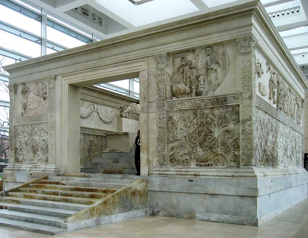 This photo shows the Ara Pacis Augustae. The actual u-shaped altar sits atop a podium inside the square wall that is seen here and demarcates the precinct's sacred space.