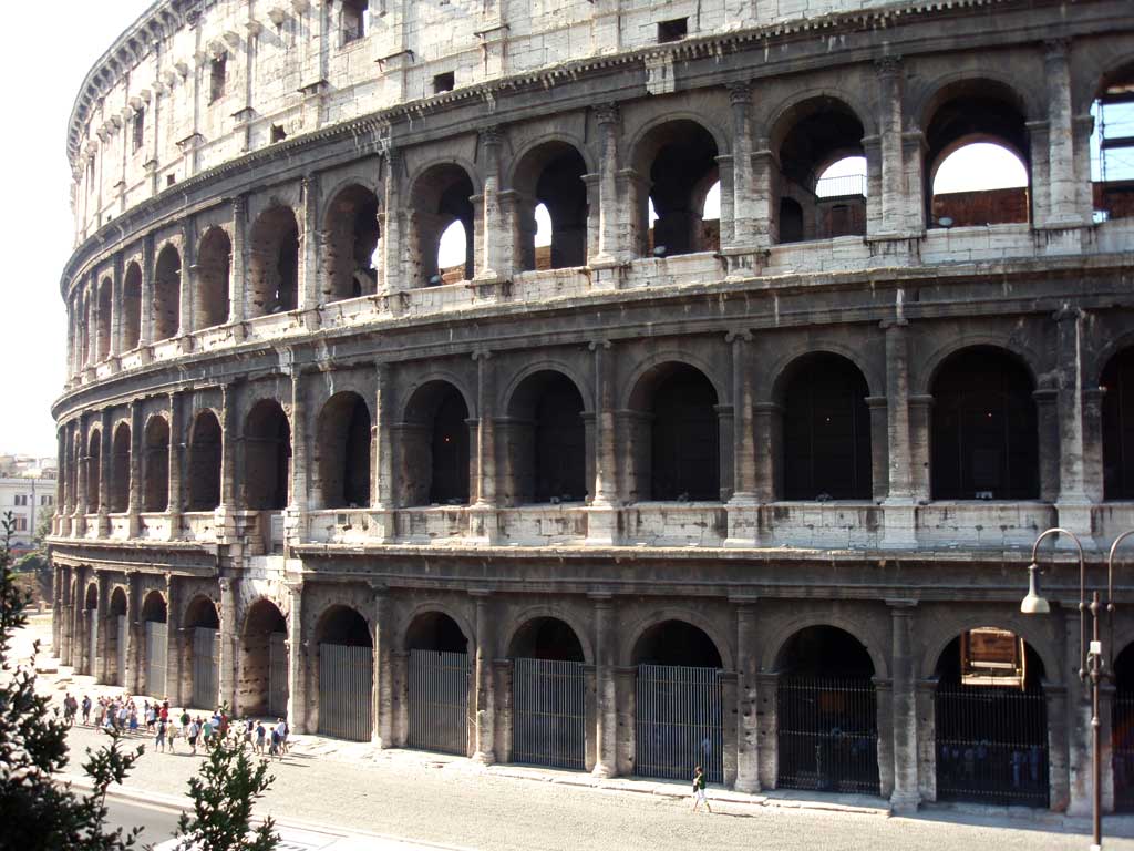 Picture of the outer exterior of the Colosseum with three rows of vaulted arches.