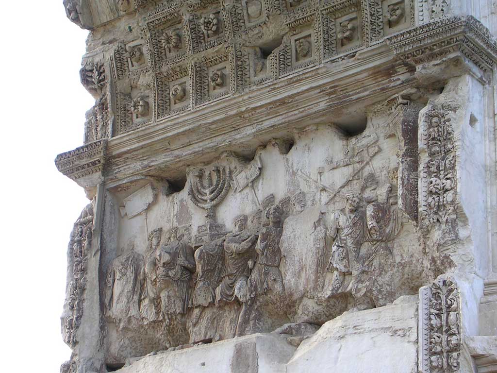A relief from within the Arch of Titus detailing a procession of Roman soldiers carrying loot from the Jewish temple, among which includes a menorah.