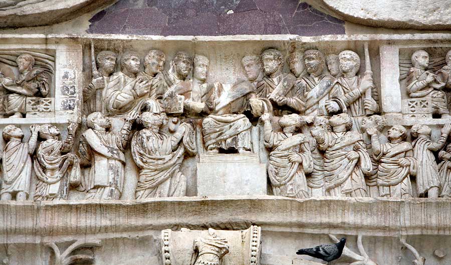This photo shows a detail of the northern frieze of the Arch of Constantine. This detail shows Constantine distributing gifts from his throne down to his supporters.