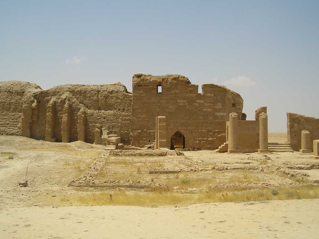 Picture of the remains of House Church at Dura-Europos. What the viewer sees here are partially standing sandstone walls as well as the remains of several rooms situated beyond the remains of the Church's entryway.