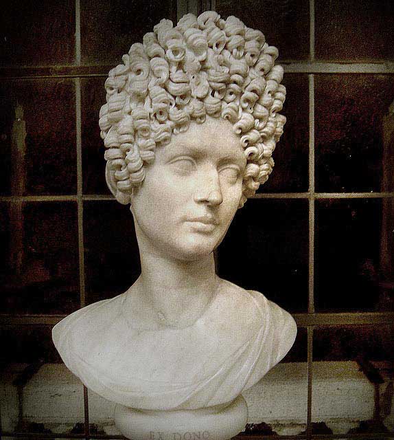 A bust of a Flavian woman. The fashionable style among women during the reign of the Flavians involved hairpieces and wigs to create a stack of curls on the crown of the head.