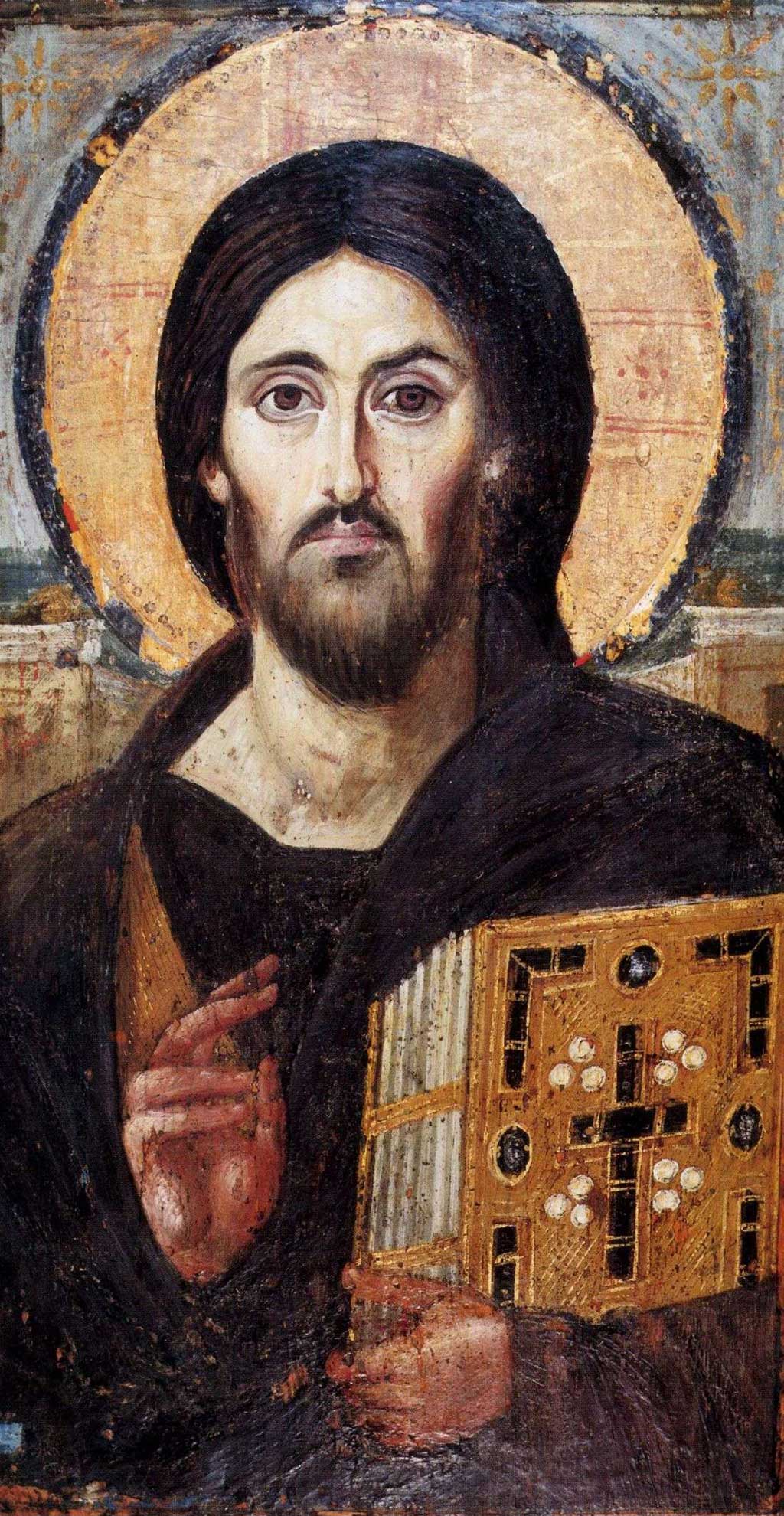 The oldest known icon depicting Jesus Christ (6th century) in Saint Catherine's Monastery, Egypt. In this image, Jesus grasps a New Testament in his left arm while making a symbol for peace with two right fingers. Also notable here is that Jesus eyes are of different color, with his brown iris dominating far more of his left eye than his right eye.