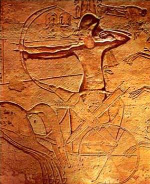 The stele depicts a two-dimensional Ramses in his horse-drawn chariot, firing a long bow in combat.