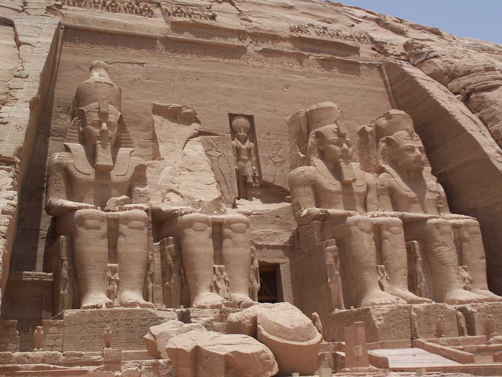 The picture is that of the entrance to Ramses' temple complex, Abu Simble. Here four massive stone depictions of a seated Ramses guard the entrance to the temple. Standing near his feet but much smaller in his size, is his wife Nefertari along with their children.