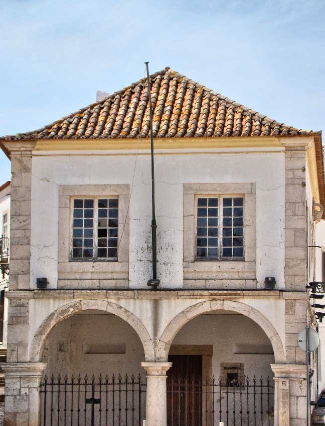 Photograph of a building that once housed the slave market in town of Lagos, Algarve, Portugal. The building is located on the PraÃ§a Infante Dom Henrique and is classified as a monument of public interest. It was built in 1691 although the trade in slaves from Africa began on this sight in the mid fifteenth century and from here slaves were shipped throughout Europe at great profit to the Portuguese monarchy and merchants of Lagos.