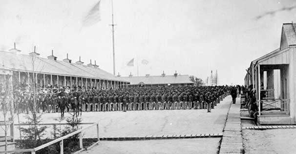 Photograph of the 26th Regiment, US Colored Troops standing at attention at Riker's Island, New York City, to fight in the U.S. Civil War.