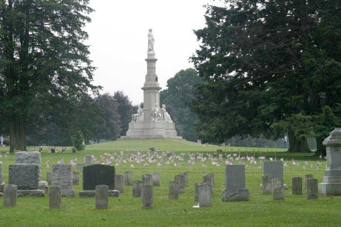 Soldiers National Monument at the center of Gettysburg National Cemetery, surrounded by tombstones.