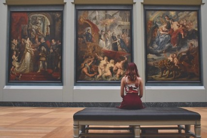 Woman looking at a painting in a museum