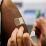 Man wearing bandage having just had a vaccine shot