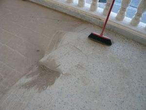 A half-swept floor and a broom