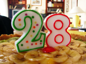 Photo of candles forming the number 28 on a birthday cake