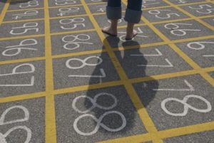 Image of a schoolyard with numbered squares on the asphalt.
