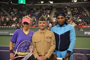 man in military uniform standing with tennis players