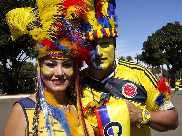A man and a woman dressed in Colombia's colors
