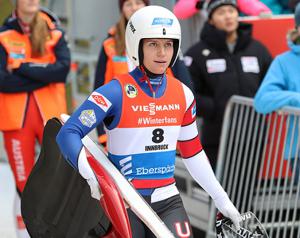 woman wearing a luge uniform and helmet