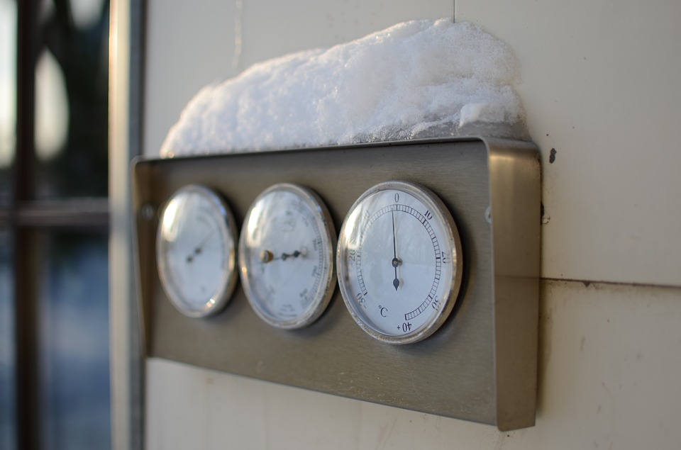 Thermometer covered in snow