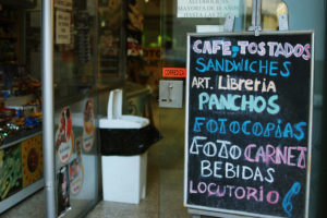 Sign advertising "cafe tostados sandwiches art libreria"