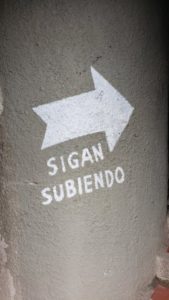 Sign reads "sigan subiendo"