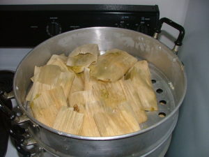 Tamales steaming in a pot