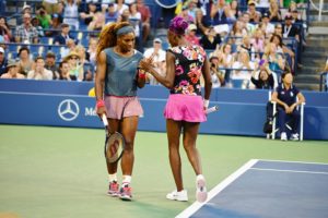 Serena and Venus Williams on a Tennis Court