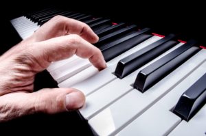 Close-up of a hand playing piano