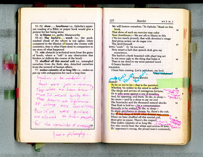 An open book with extensive highlights and margin notes.