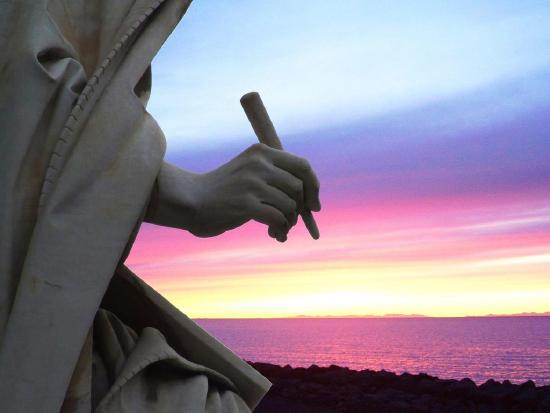 Image of a sunset in background with stone statue with hand and writing implement on the left.  "Writing Sunset Roma Italy Italia - Creative Commons by gnuckx" by gnuckx is marked under CC0 1.0. To view the terms, visit https://creativecommons.org/licenses/cc0/1.0/ 