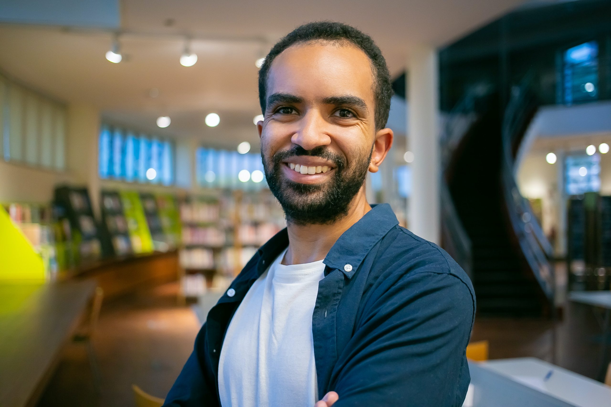 Man smiling in library