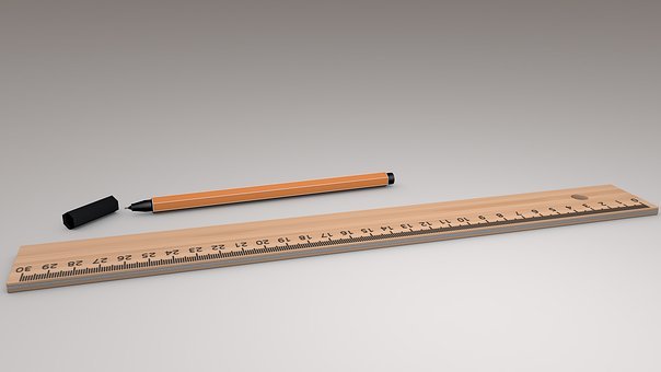 open pen next to wooden ruler