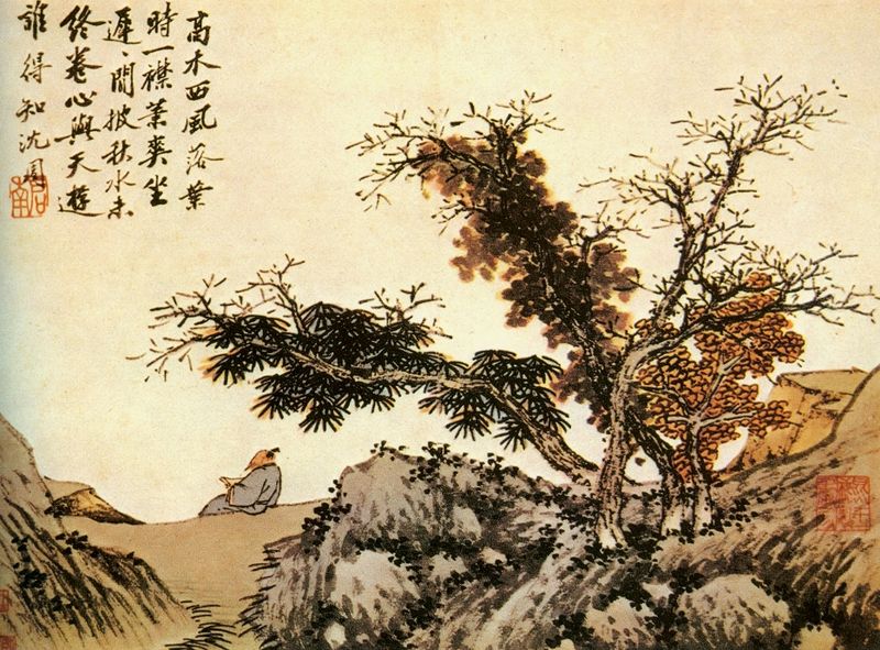 Man reading in Autumn scene with trees