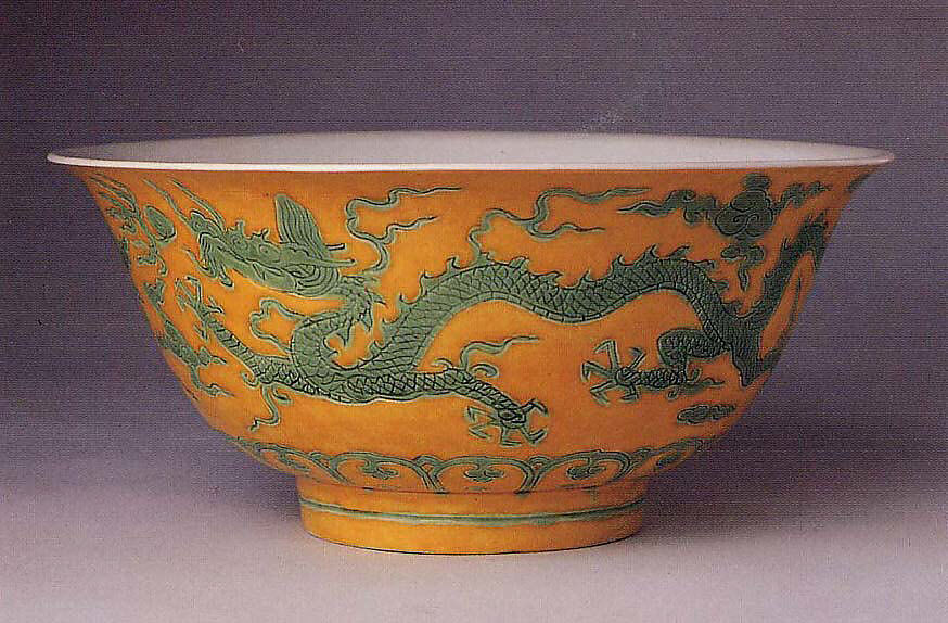 Orange ceramic bowl with green dragons