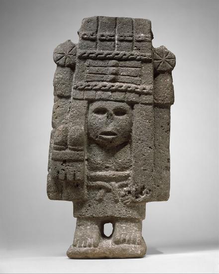 a stone carving of a person with an elaborate headdress