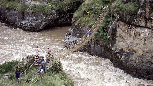 rope bridge across a raging river